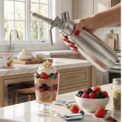 Person using a whipped cream dispenser over a dessert in a kitchen setting. Premium 8g nitrous oxide N2O whipped cream dispenser chargers.