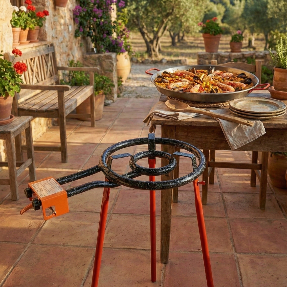 Garcima Mediterraneo authentic carbon steel paella pan with outdoor gas burner set. Rustic table and paella pan full. 