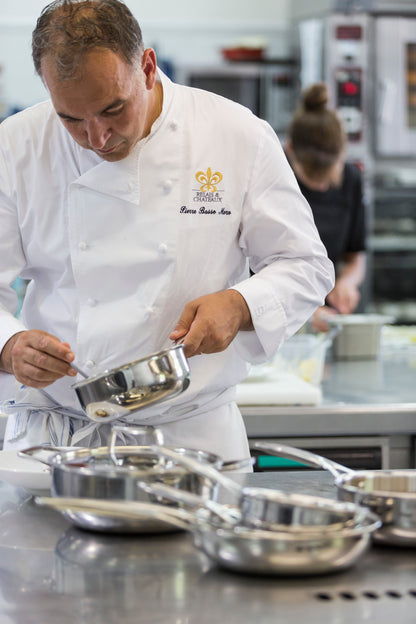 Renowned chef Pierre Basso Moro cooking in a professional kitchen with Cristel Castel'Pro stainless steel cookware.