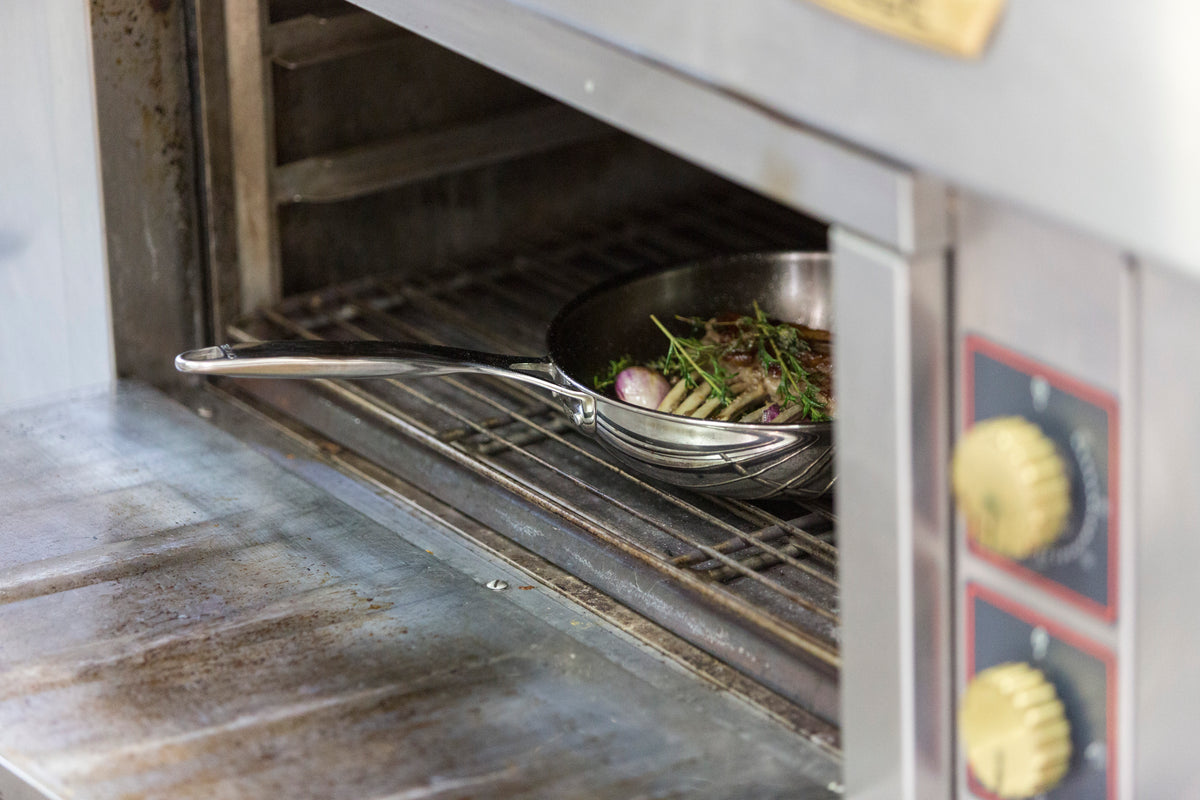 The Cristel Castel'Pro stainless steel deep frying pan inside a professional oven, demonstrating oven-safe cooking performance.